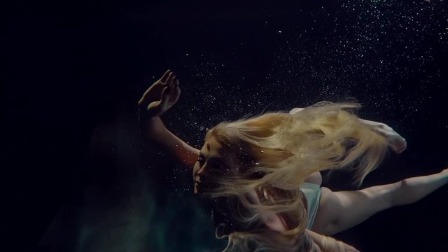Woman swimming underwater.