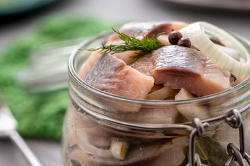 Marinated herring in a jar closeup.