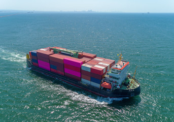 Aerial view small container ship full load container for logistic, import export, shipping or transportation.