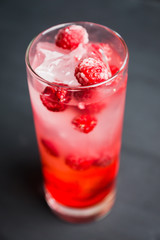 Sweet raspberry Tom collins cocktail. Selective focus. Shallow depth of field.