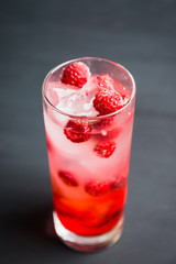 Sweet raspberry Tom collins cocktail. Selective focus. Shallow depth of field.