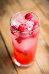 Sweet raspberry Tom collins cocktail. Selective focus. Shallow depth of field.