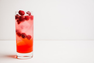 Sweet raspberry Tom collins cocktail. Selective focus. Shallow depth of field.