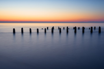 Stakes on the Baltic sea at sunset time, Karwia village, Poland