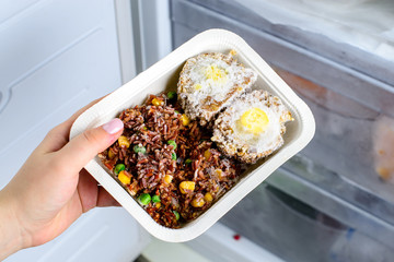 frozen food from the freezer in the female hand