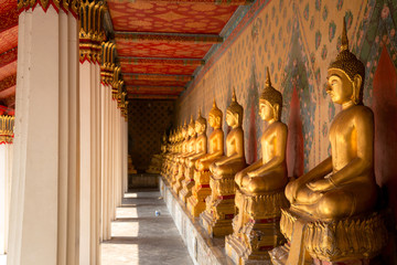Row of golden buddha statue at Wat Arun, Bangkok Thailand.