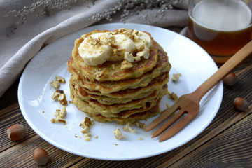 Stack of oatmeal pancake with banana, nuts and honey Healthy Breakfast	