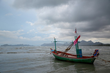 Naklejka na ściany i meble Thai long tail boat during low tide in ocean