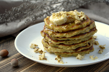 Stack of oatmeal pancake with banana, nuts and honey Healthy Breakfast