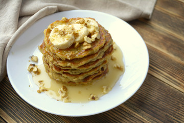 Stack of oatmeal pancake with banana, nuts and honey Healthy Breakfast	