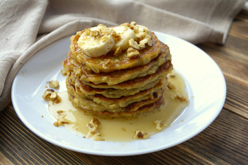 Stack of oatmeal pancake with banana, nuts and honey Healthy Breakfast	