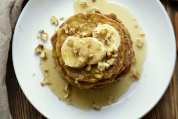 Stack of oatmeal pancake with banana, nuts and honey Healthy Breakfast	