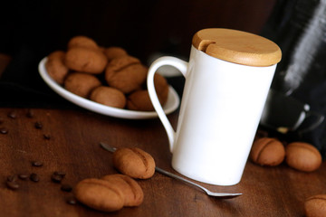 Sweet cookies shaped as cofee beans served with coffee cup