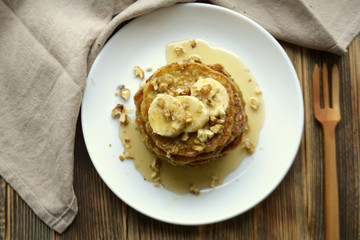 Stack of oatmeal pancake with banana, nuts and honey Healthy Breakfast