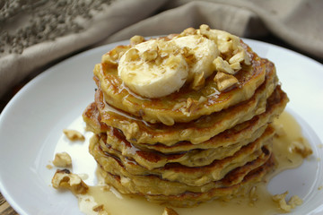Stack of oatmeal pancake with banana, nuts and honey Healthy Breakfast