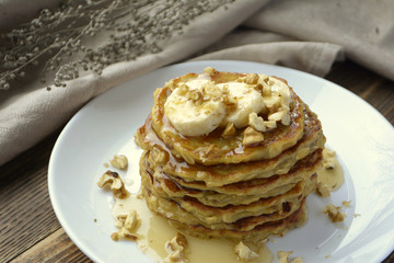 Stack of oatmeal pancake with banana, nuts and honey Healthy Breakfast	