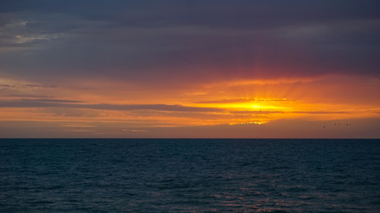 A new day began, the sun rose above the turbulent sea. The wind plays in waves and accelerates the...