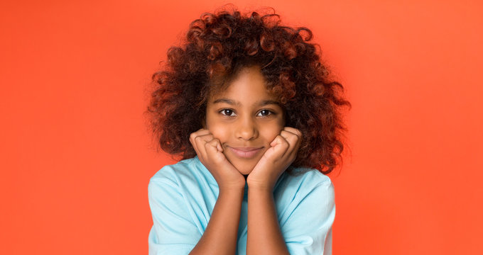 Little african-american girl posing and looking at camera