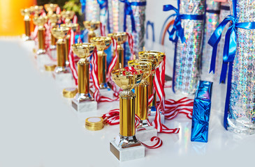 Reward gifts and cups are prepared for ceremony on sport competition tournament and medals