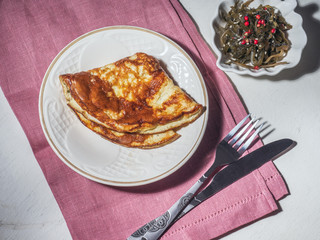 Freshly cooked omelet and sea kale salad for breakfast
