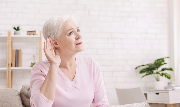 Elderly woman with hearing loss at home