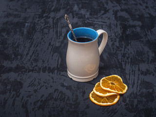 hot tea high light mugs white with blue against a dark background with orange chips.