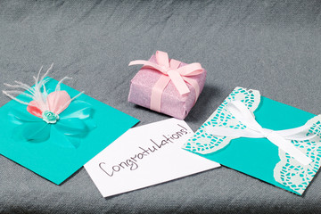 Handmade greeting cards. Near gift in wrapping paper, tied with a ribbon. Original gift.
