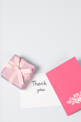 Handmade greeting card. Near gift in wrapping paper, tied with a ribbon. Original gift.