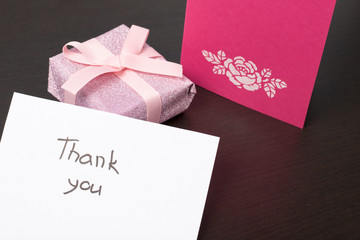 Handmade greeting cards. Near gift in wrapping paper, tied with a ribbon. Original gift.