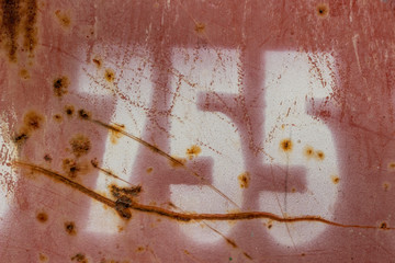 number seven hundred two painted on rusty red metal, number 702