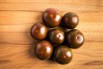 group of dark red kumato tomatoes