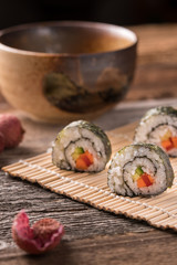 Three delicious vegan sushi rolls, vertical close-up
