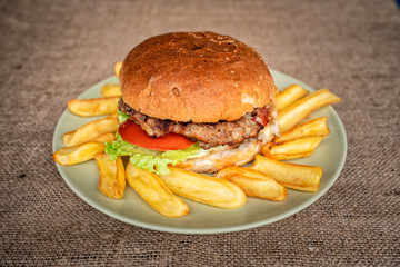 Tasty Homemade Hamburger with Lettuce, Tomato and fried potato