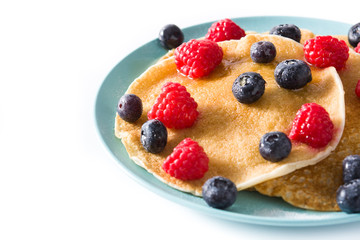 Pancakes with raspberries, blueberries and honey isolated on white background. Copyspace