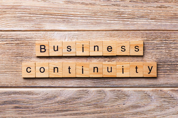 Business Continuity word written on wood block. Business Continuity text on wooden table for your desing, concept