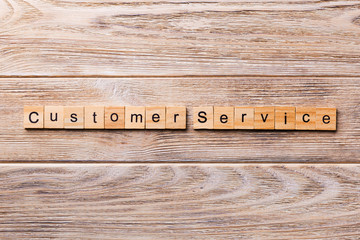 customer service word written on wood block. customer service text on wooden table for your desing,...