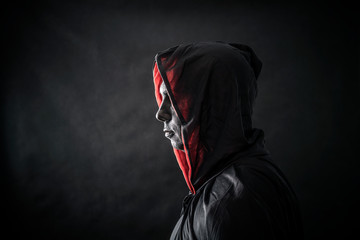 Fototapeta na wymiar Hooded man in the dark