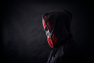 Hooded man in the dark