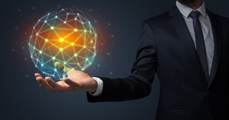 Businessman in suit holding global connection symbol on his hand
