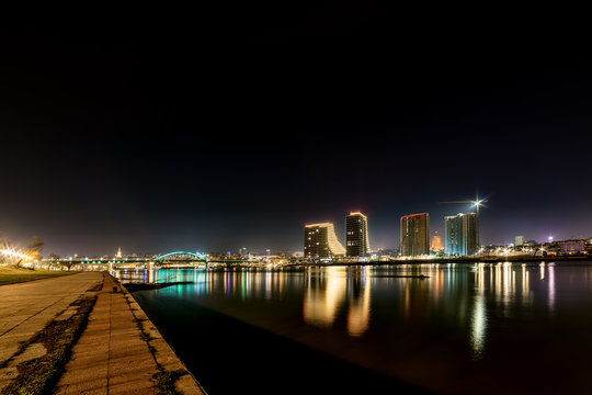 Belgrade, Serbia - February 10, 2019: Belgrade waterfront on the Sava River. Panorama of Belgrade by night with reflection.