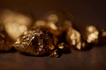 selective focus of golden stones on blurred background