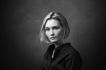 Fototapeta premium Dramatic black and white portrait of a beautiful woman on a dark background