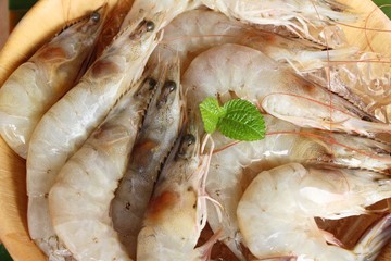 Fresh shrimp for cooking on wood background