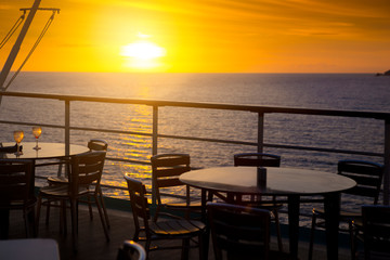 Wine glasses on balcony overlooking at sunset