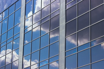 Fototapeta na wymiar sky reflection in the windows of an office building