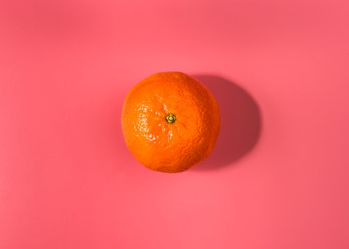 Colorful Food & Drink Still Life Concept. Color Riot Food Photography. Fresh Fruits & Vegetables On Bright Color Background. Orange Mandarin Pink Background. Closeup. Top View