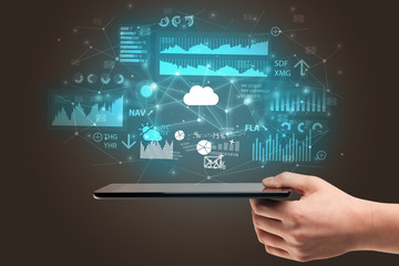 Businessman using phone with flying application icons around
