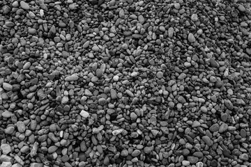 Black and white background of small and large gravel. Stone background for post, screensaver, wallpaper, postcard, poster, banner, cover, header for website. High quality photography