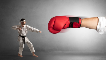 Little man fighting with a giant red boxing glove

