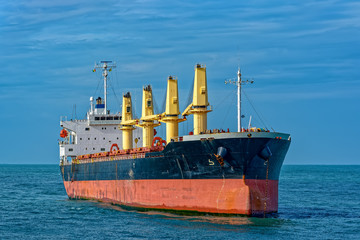 Bulk carrier vessel is awaiting loading of bauxite ore at outer anchorage of Kamsar port, Guinea,...